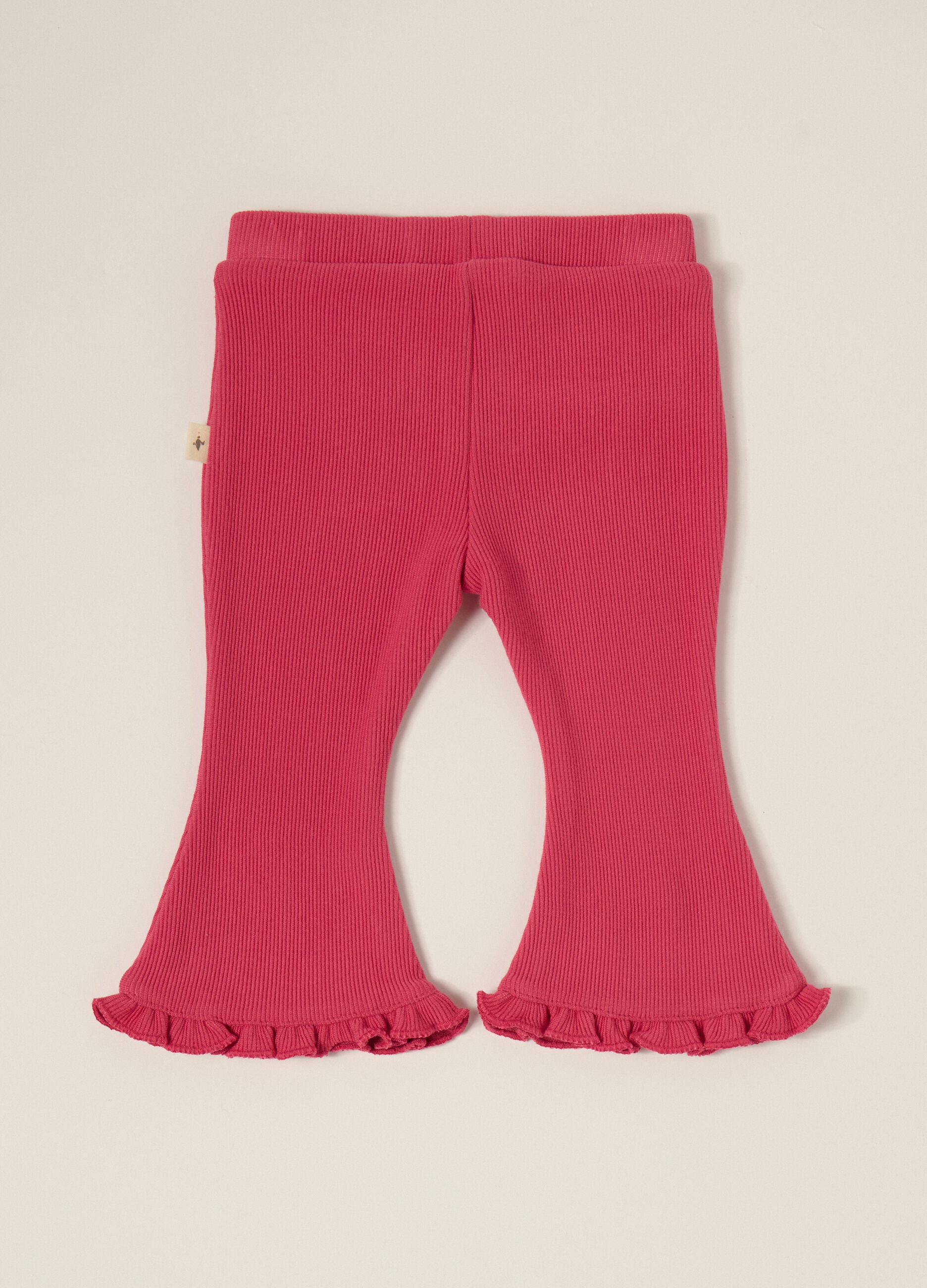 Pantaloni rosa elasticizzati con volant